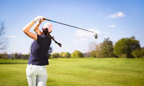 ThinkstockPhotos-474050972 Woman golf player teeing off.